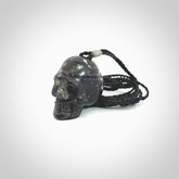This picture shows a medium sized Snowflake Obsidian stone skull pendant that we have hand carved. It is polished to a soft shine and is a very striking piece. Provided with an adjustable black cord.
